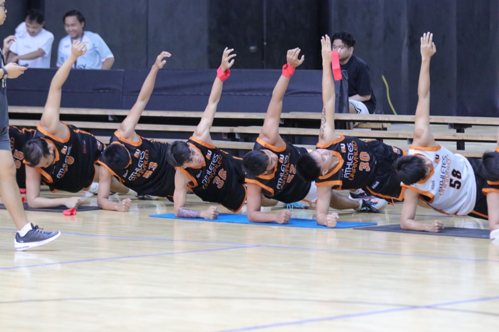 Athletes Unrivaled players stretching together before training